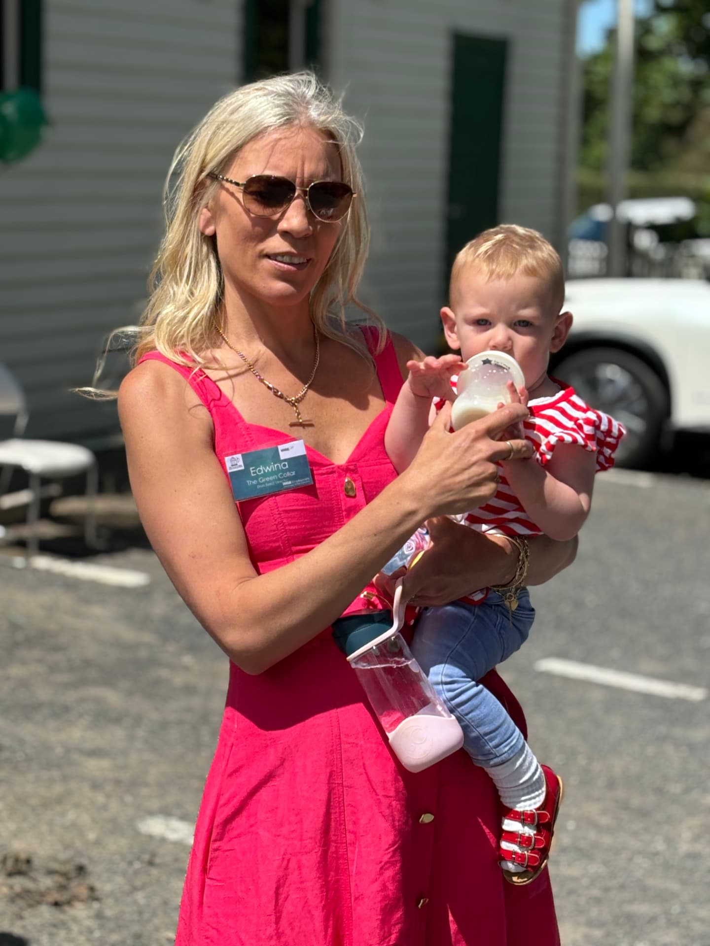 Edwina from The Green Collar holding a child at a Green Collar event