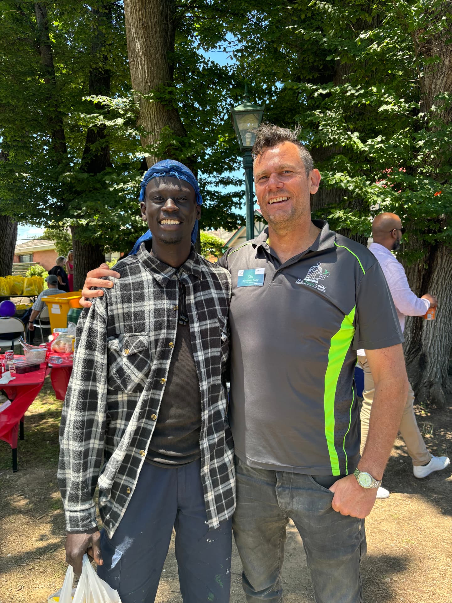 Stu Holmes (right) with a Green Collar crew member at a community barbecue